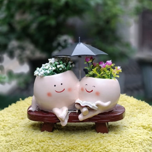 Mother with kid smiley with umbrella planter