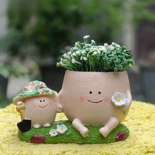 Mother kid smiley planter on grass